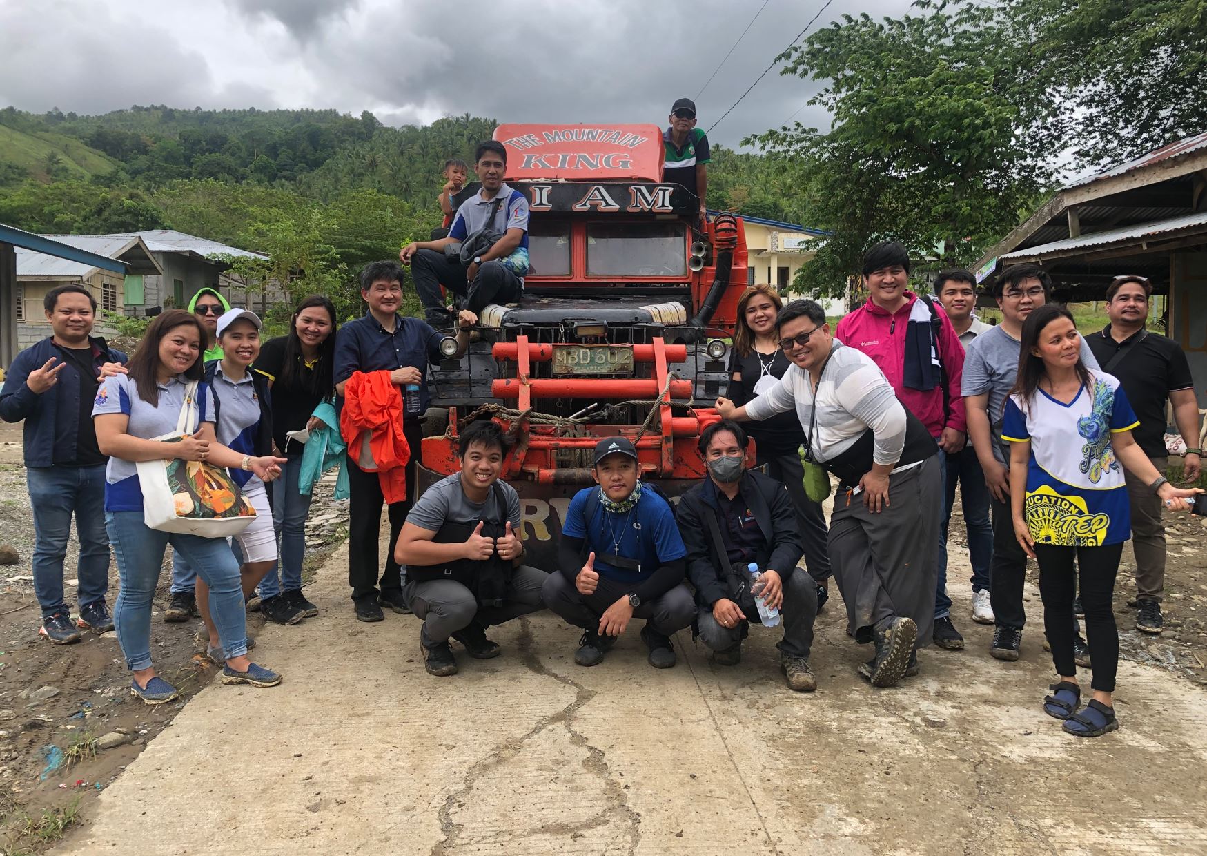 Photo: Inchul and the Mindanao solar home system mission in front of off-road truck which help him and the team make it through muddy road and stream.